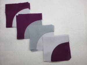 A group of four napkins that are folded in half.