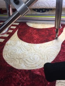 A machine cutting fabric with a large circle.