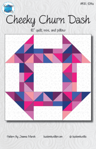 A quilt with a geometric design in pink and blue.