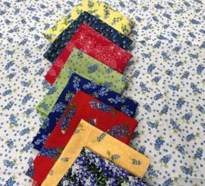 A bunch of different colored fabric on top of the ground