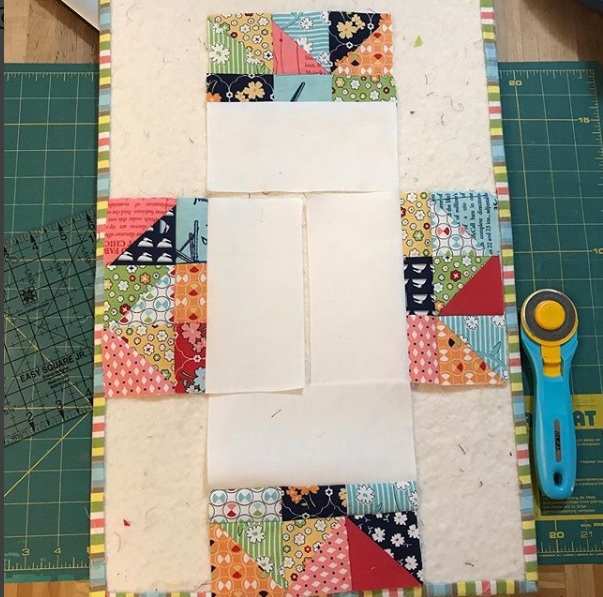 A quilt is being made with a patchwork design.