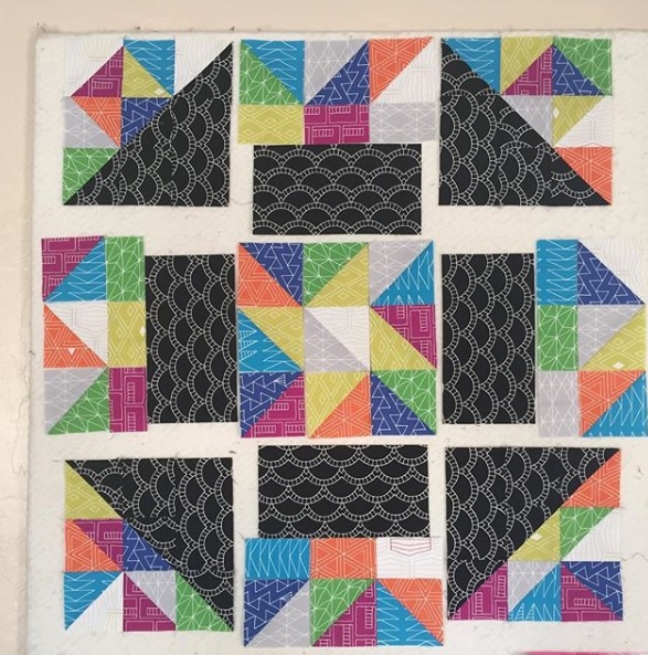 A quilt with different colored squares and black.