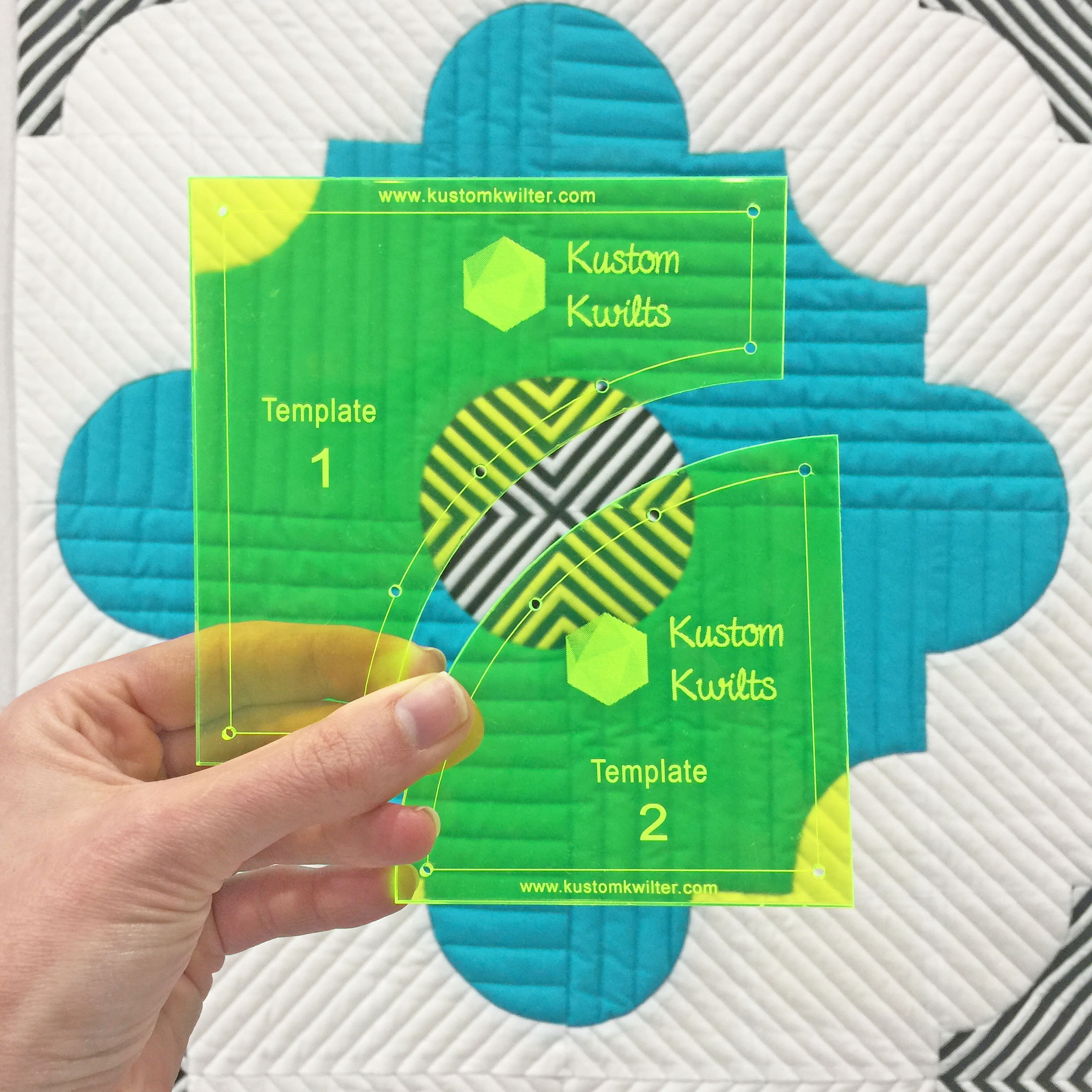 A person holding up two different sized squares.