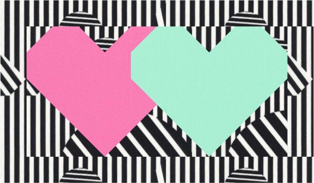 A pink and blue heart on top of black and white stripes.