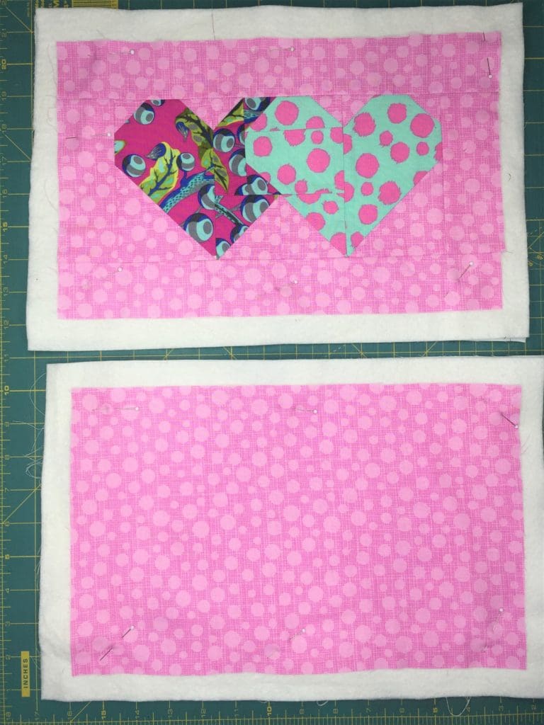 A pink and blue heart on top of black and white stripes.