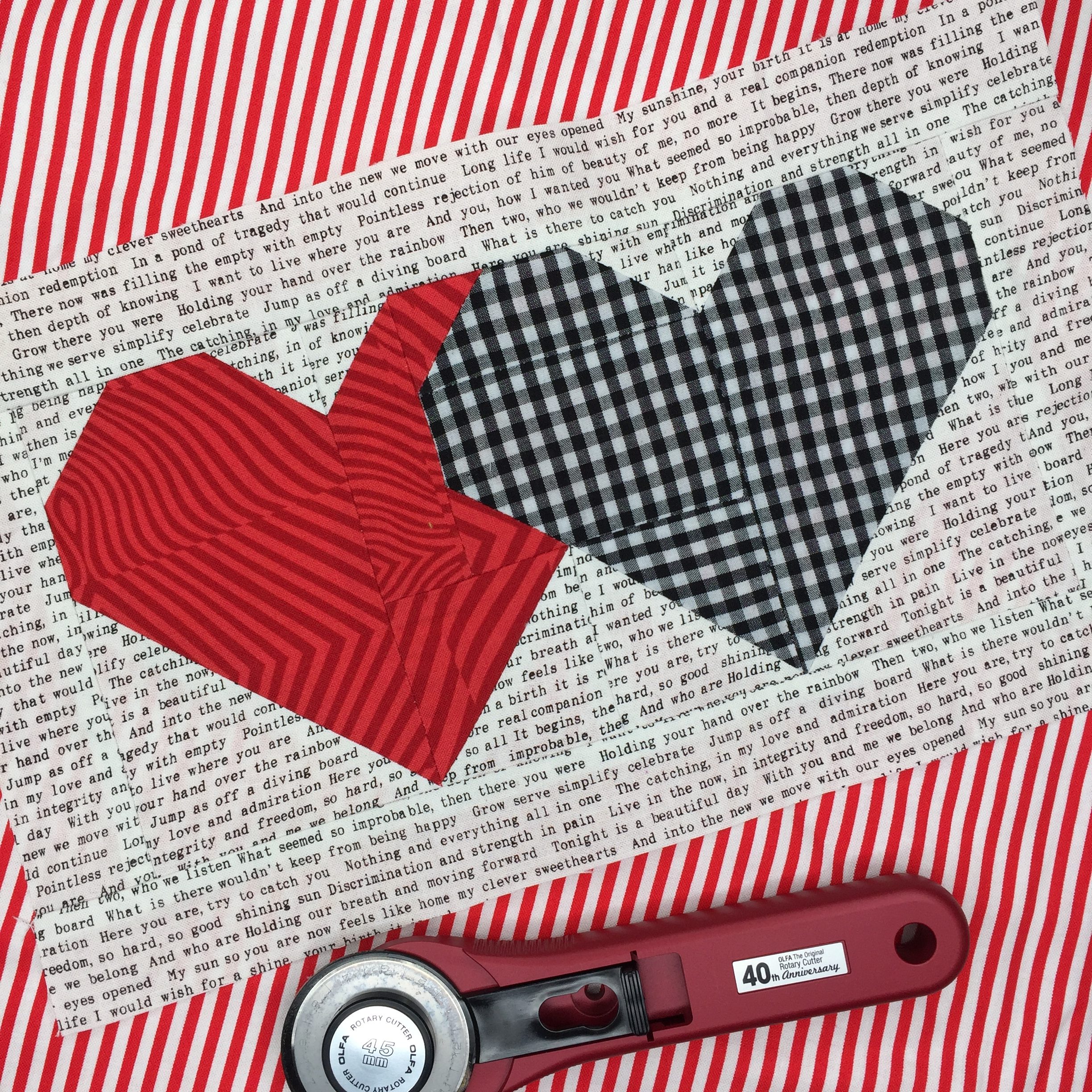 A red and white striped table cloth with two hearts on it.