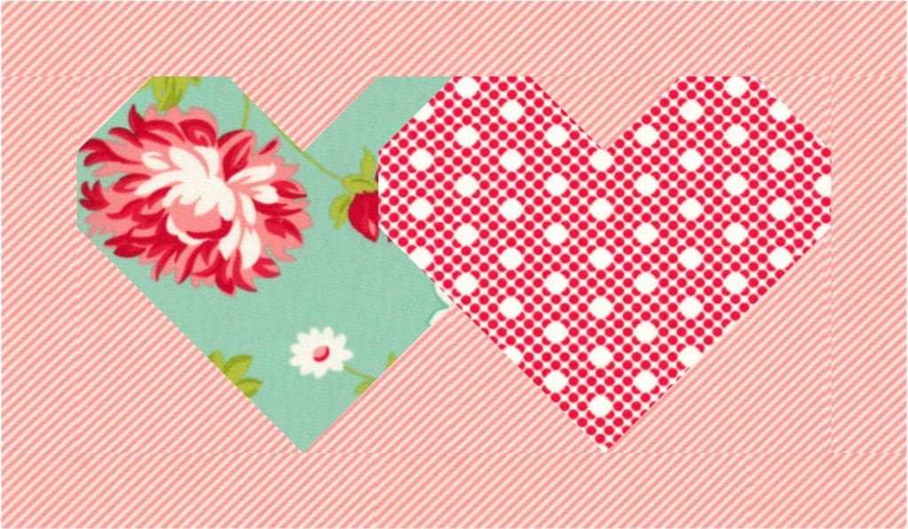 A heart shaped fabric with flowers and polka dots.