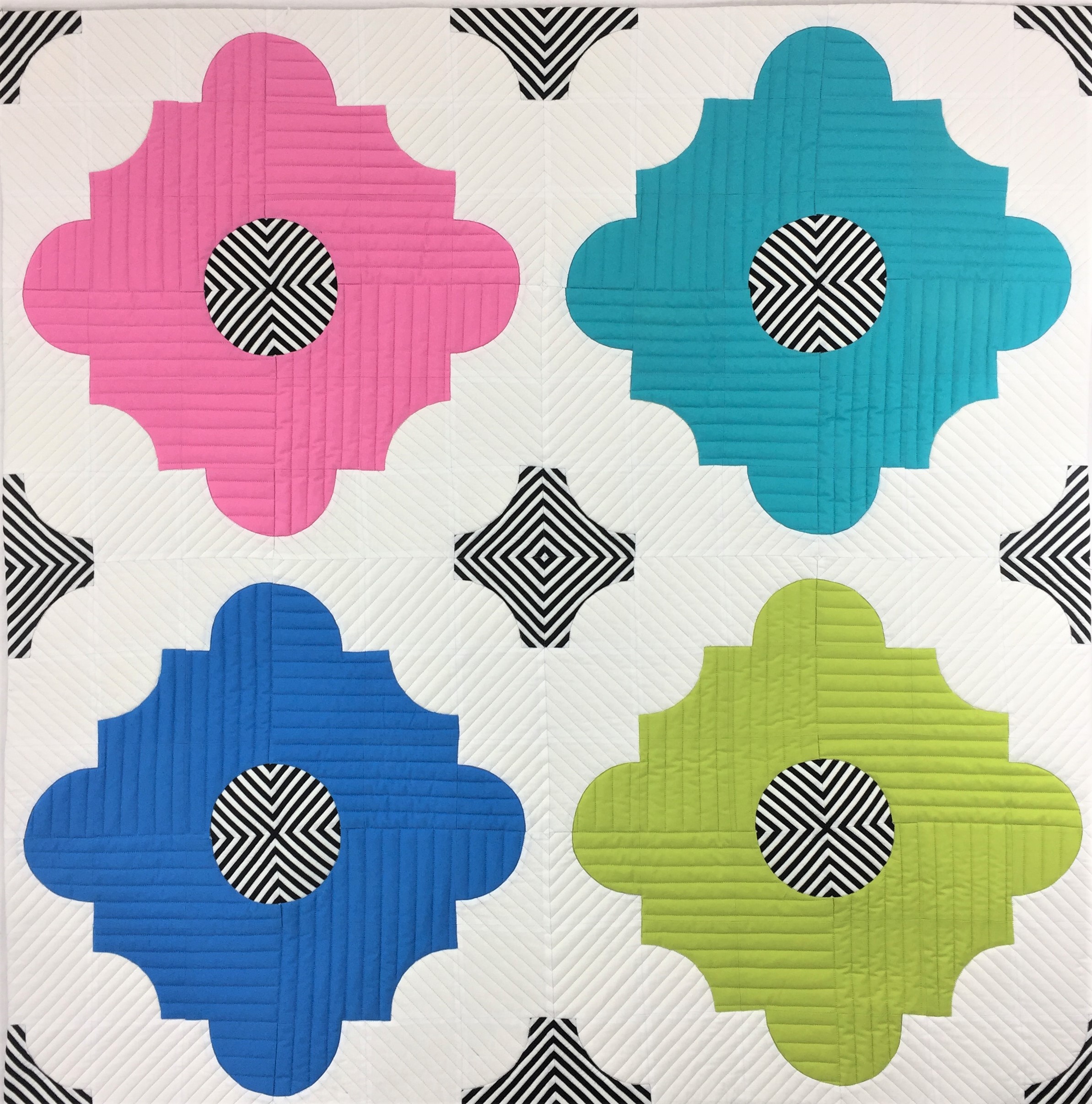 A colorful tile pattern with black and white dots.