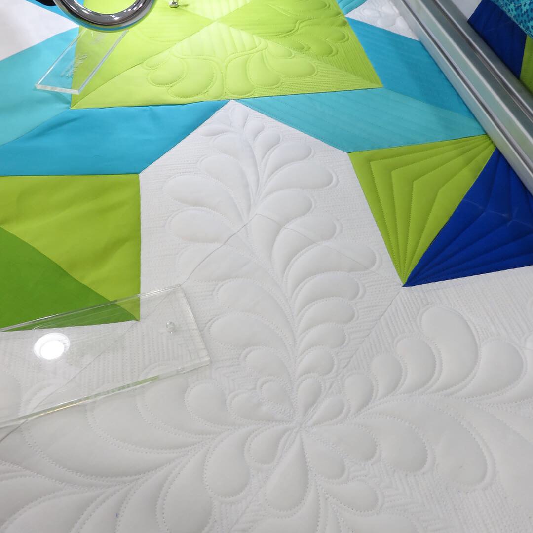 A quilt is being made with the help of a machine.