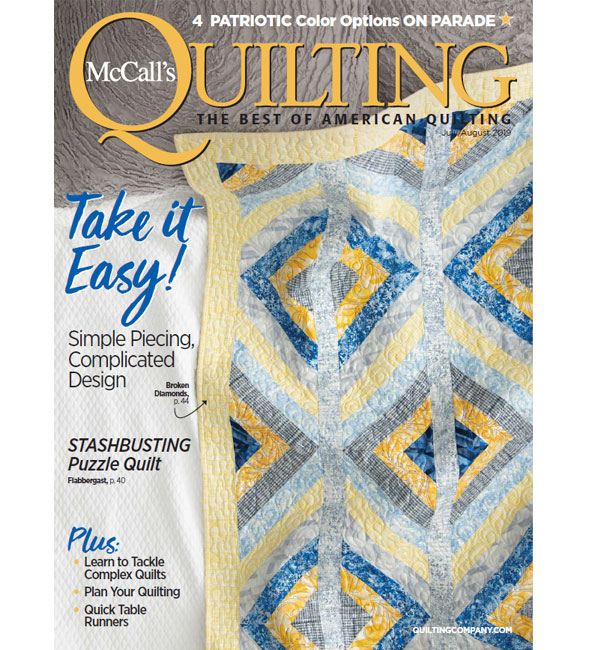 A magazine cover with a quilt on it.