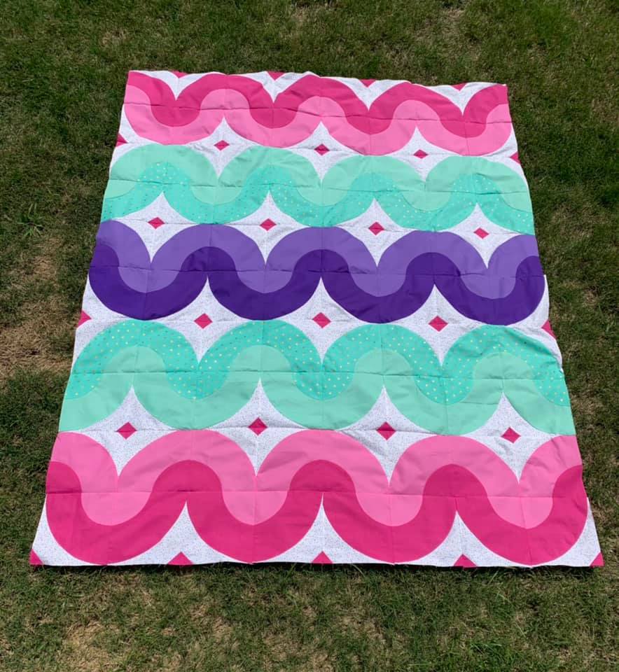 A blanket that is sitting on the grass.