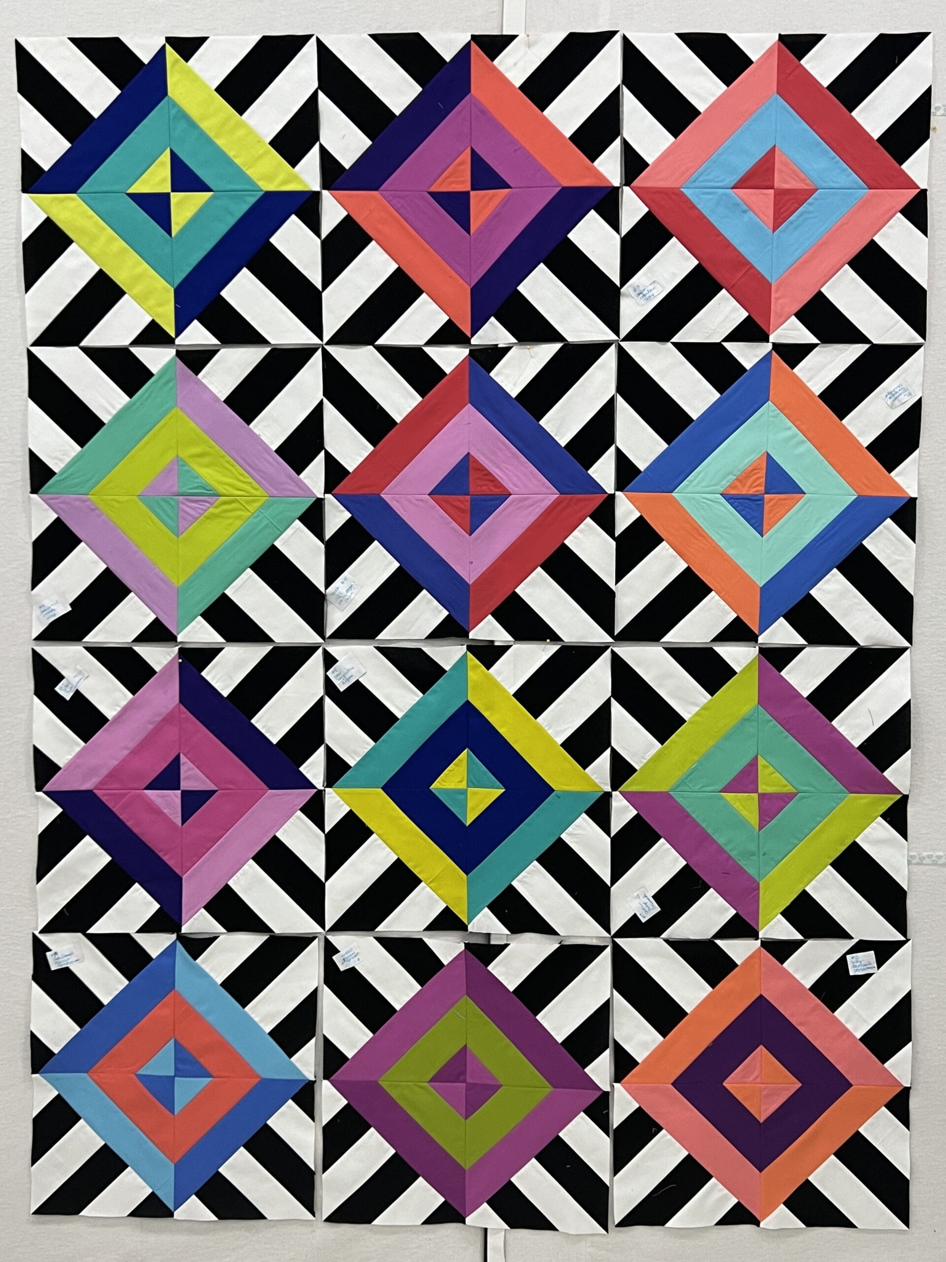 A quilt with different colored squares and triangles.