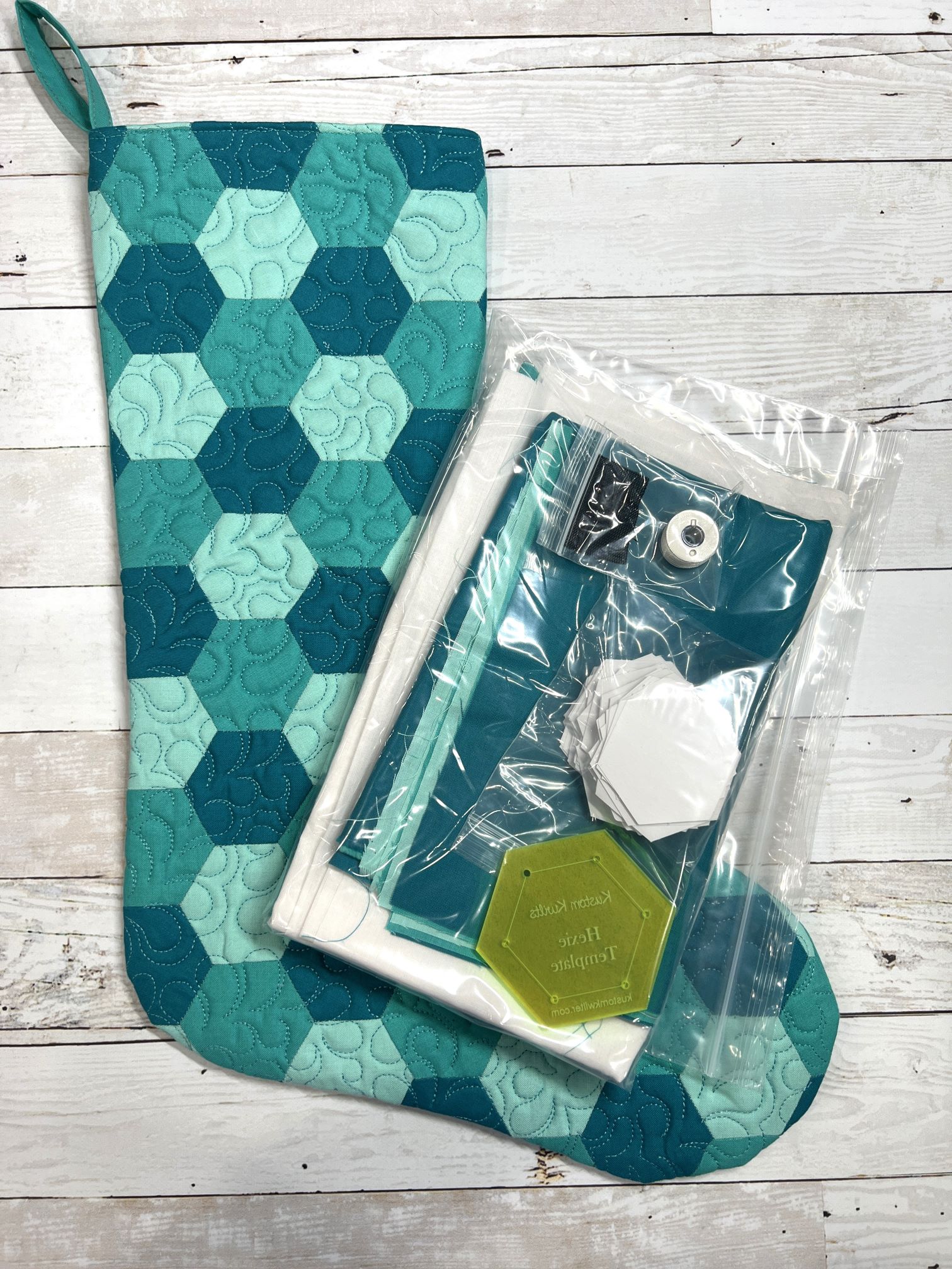 A blue and green quilt sitting on top of a wooden table.