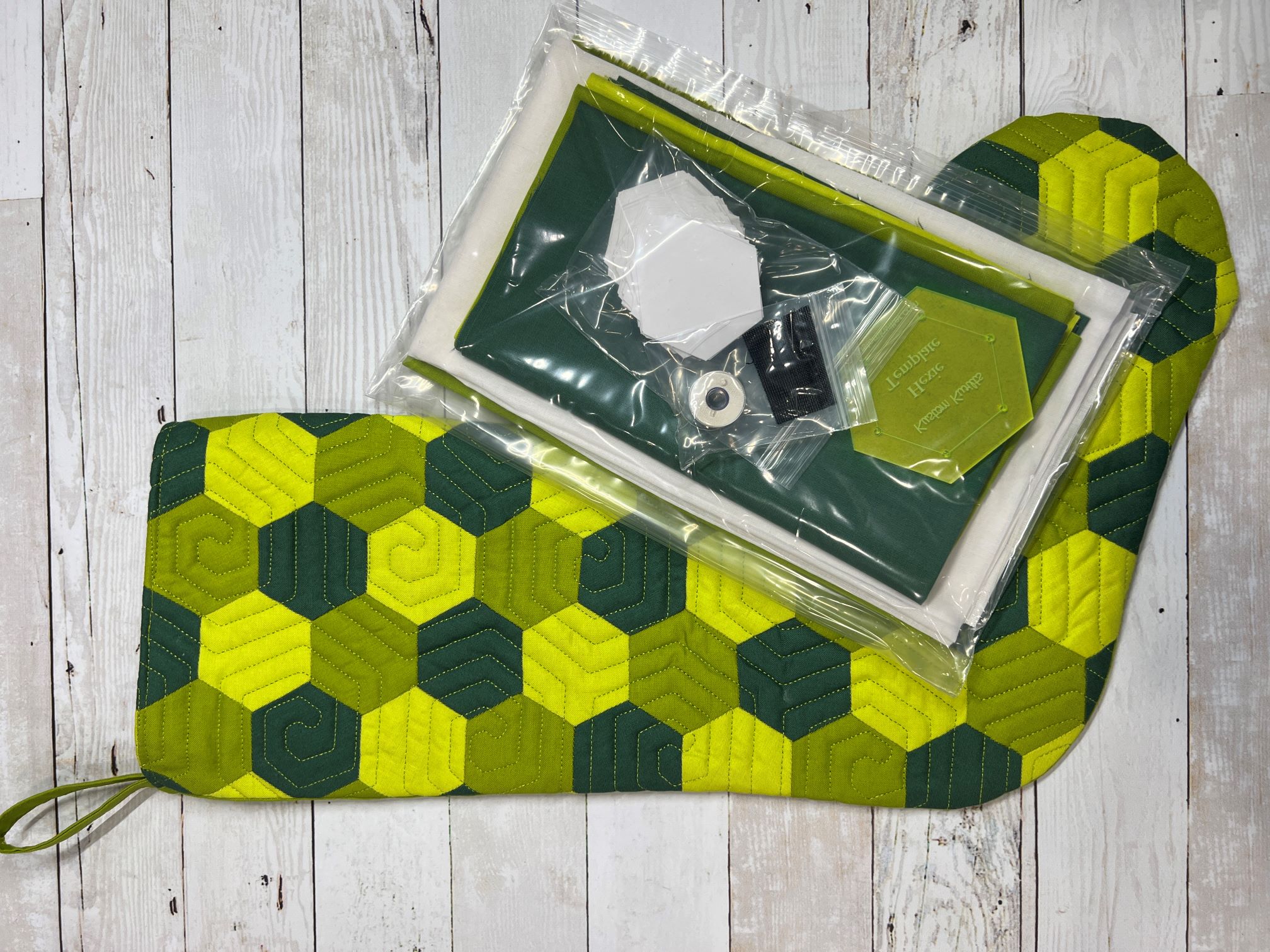 A green and yellow mat with a box of beads