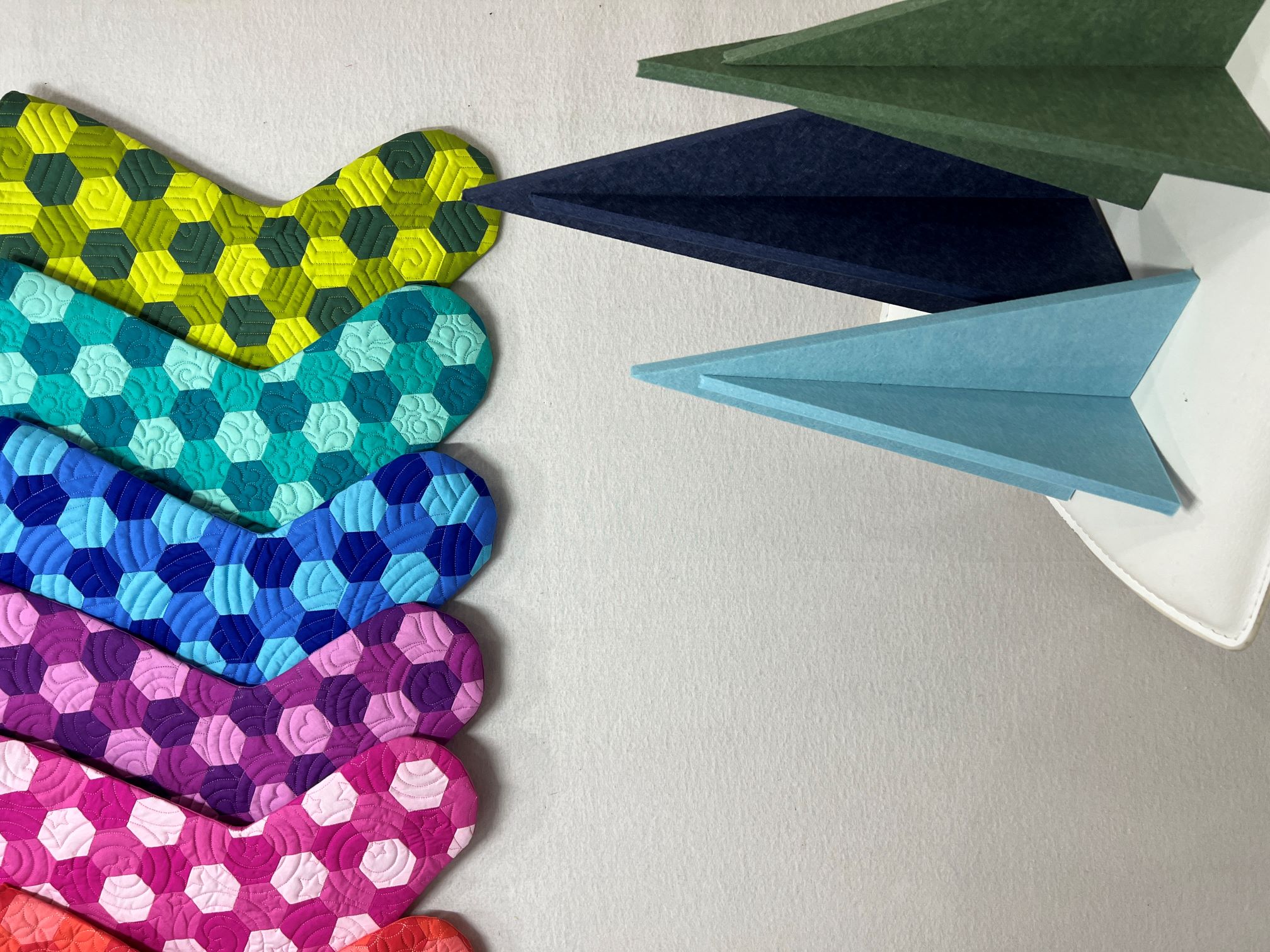 A wall with many different colored socks hanging on it.